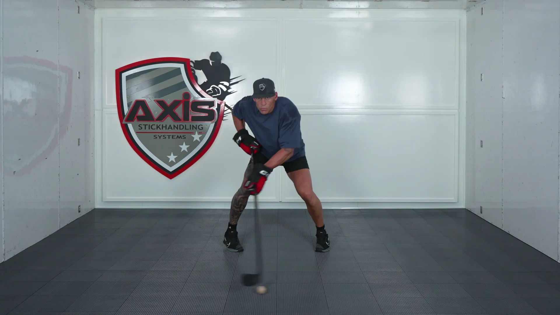 A coach stickhandling a ball in close, then pushing it out to full reach
